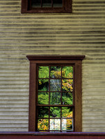 Fall leaves reflect off window on old homestead house Indaina Du