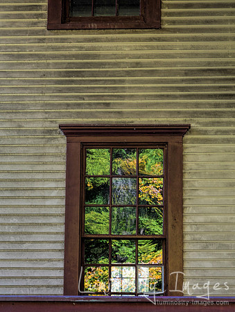 Fall leaves reflect off window on old homestead house Indaina Du