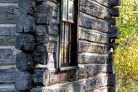 Closeup of Log cabin with fall leaves in window. Indiana State D