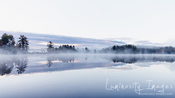 Misty fall sunrise on Bearskin Lake, WI.