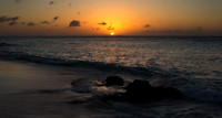 Sunset over Caribbean ocean with reflections in tidal pool.Bonai