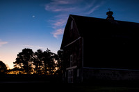 Venus and moon shine brightly over Red Barn at sunrise. IL
